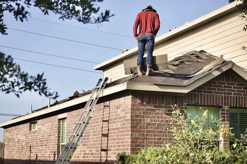 Professional roofer working on a residential roof in Seabrook
